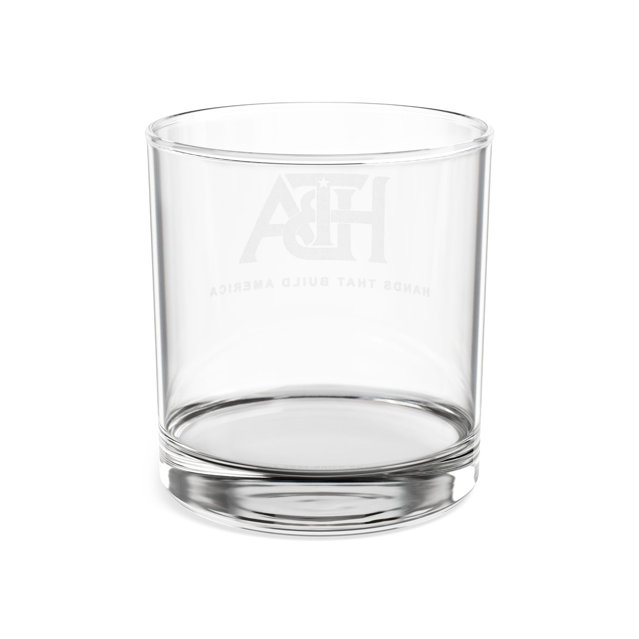 Clear lowball glass with 'HTBA' branding on a white background