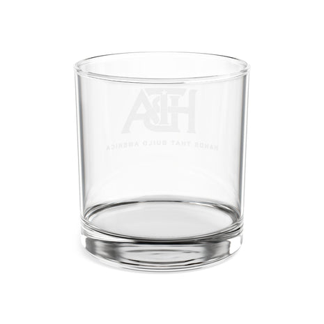 Clear lowball glass with 'HTBA' branding on a white background