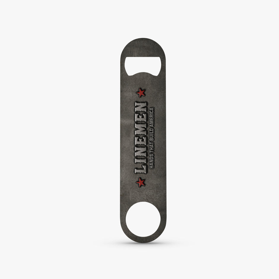 A dark gray metal bottle opener with a distressed finish, featuring the text 'LINEMEN' and 'GRADUATE PEACH COUNTY AMERICA' with red star accents, shown on a light gray background.