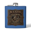 A blue metal flask with a silver screw cap and side spout, featuring a large vintage-style front graphic that reads “MASON Bricklayer & Stone Worker” with an illustrated mason at a workbench.