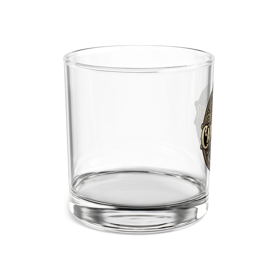 Clear glass tumbler with a logo on a white background
