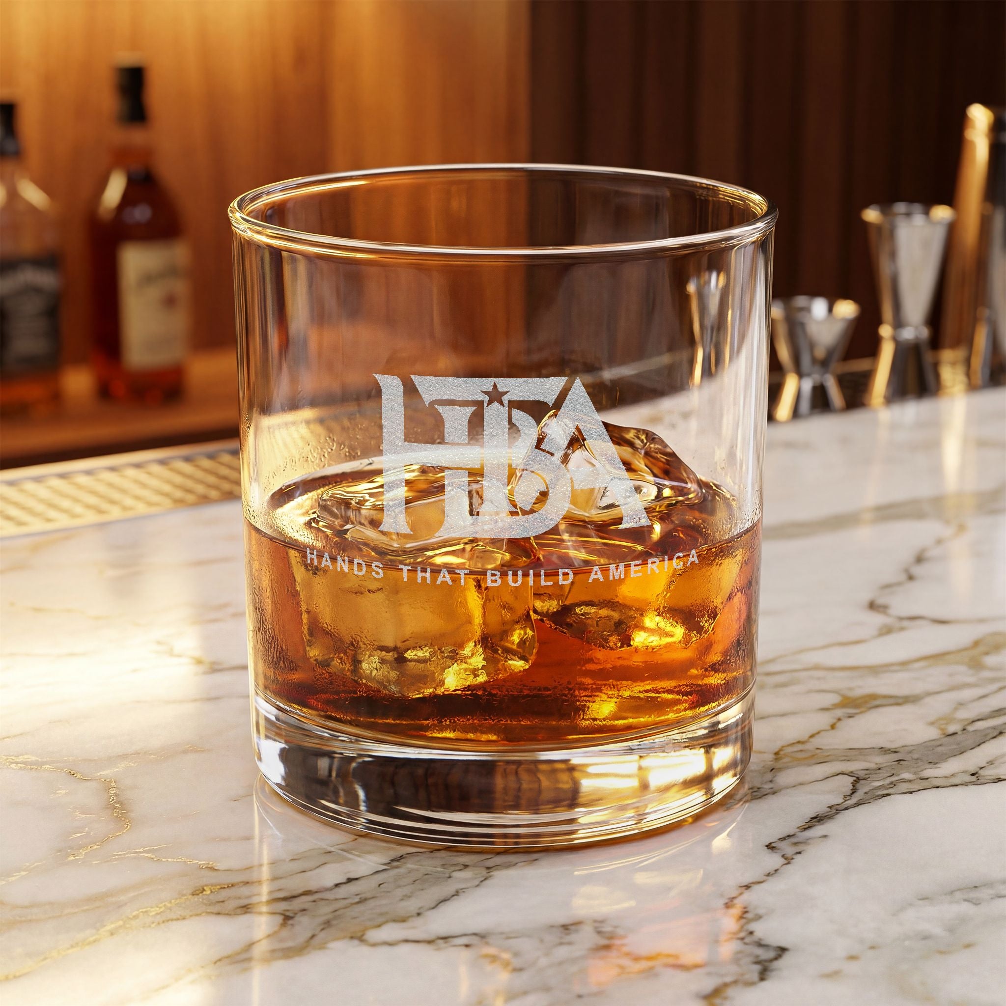 Glass of whiskey with HTBA logo (on a marble surface)