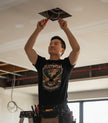 Black t-shirt with an eagle graphic and 'Electrician American Pride' text on a white background