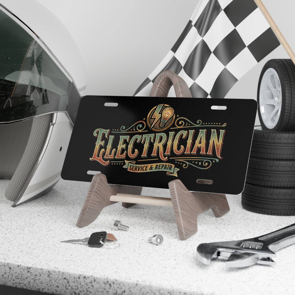 License plate with 'Electrician Service & Repair' text on a stand, surrounded by tools and a helmet.