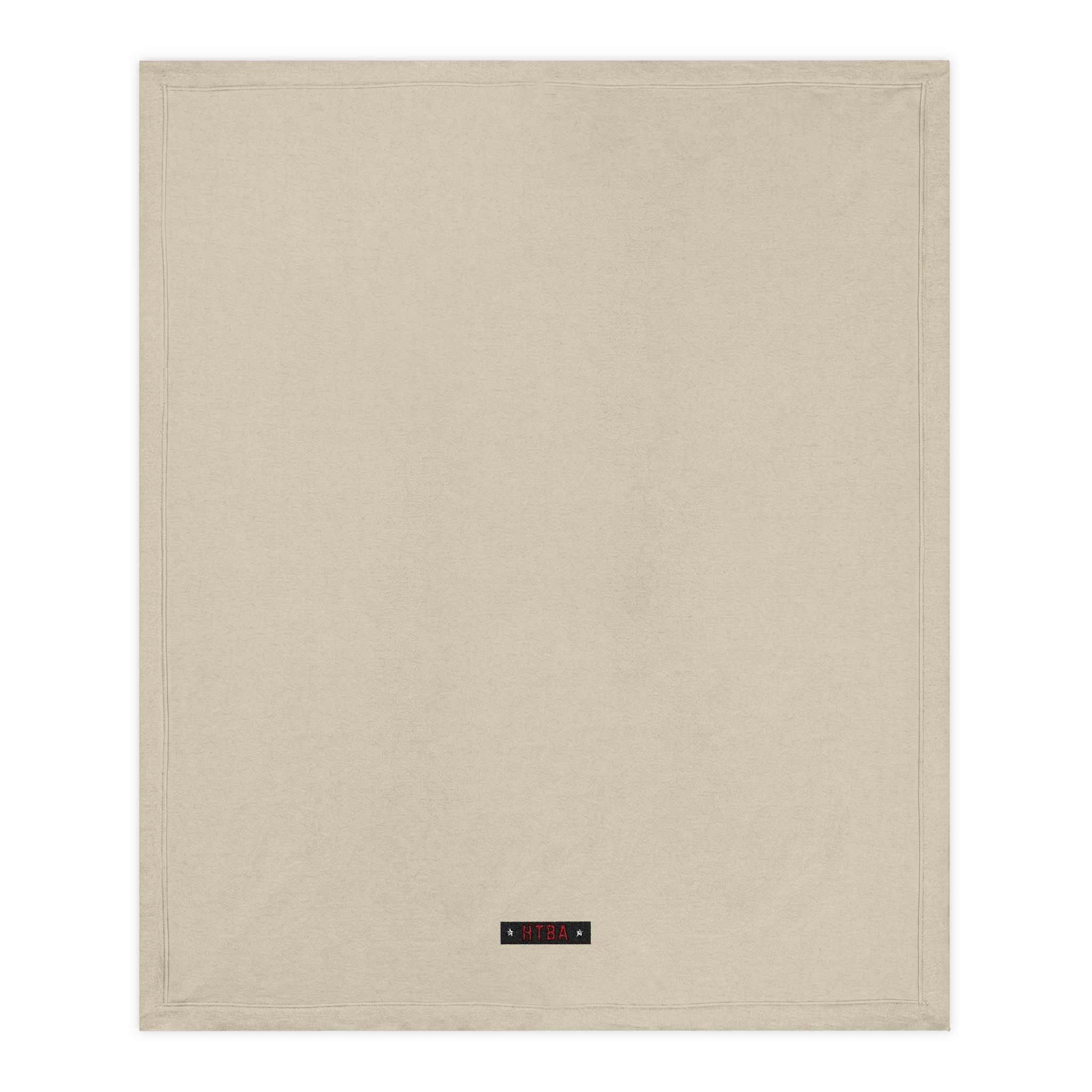Beige Throw Blanket with HTBA brand label on a white background