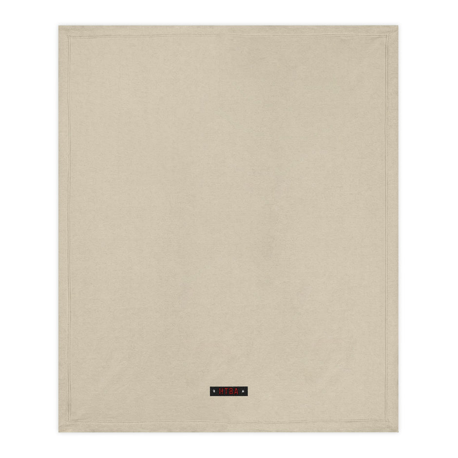 Beige Throw Blanket with HTBA brand label on a white background