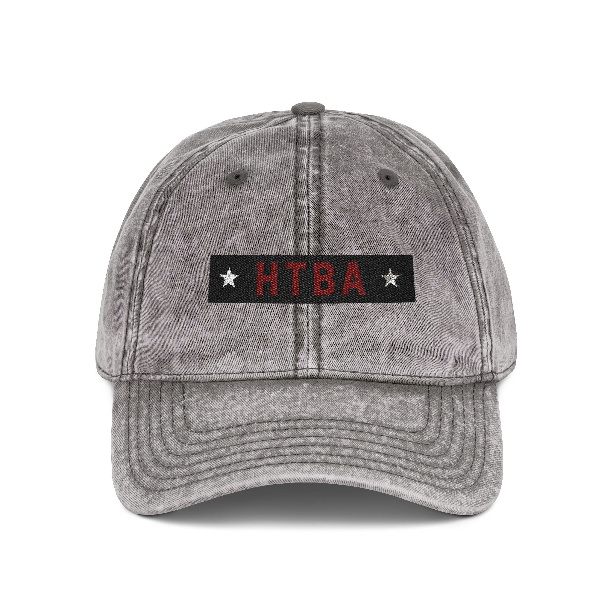 Gray denim cap with 'HTBA' logo on a white background