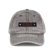 Gray denim cap with 'HTBA' logo on a white background