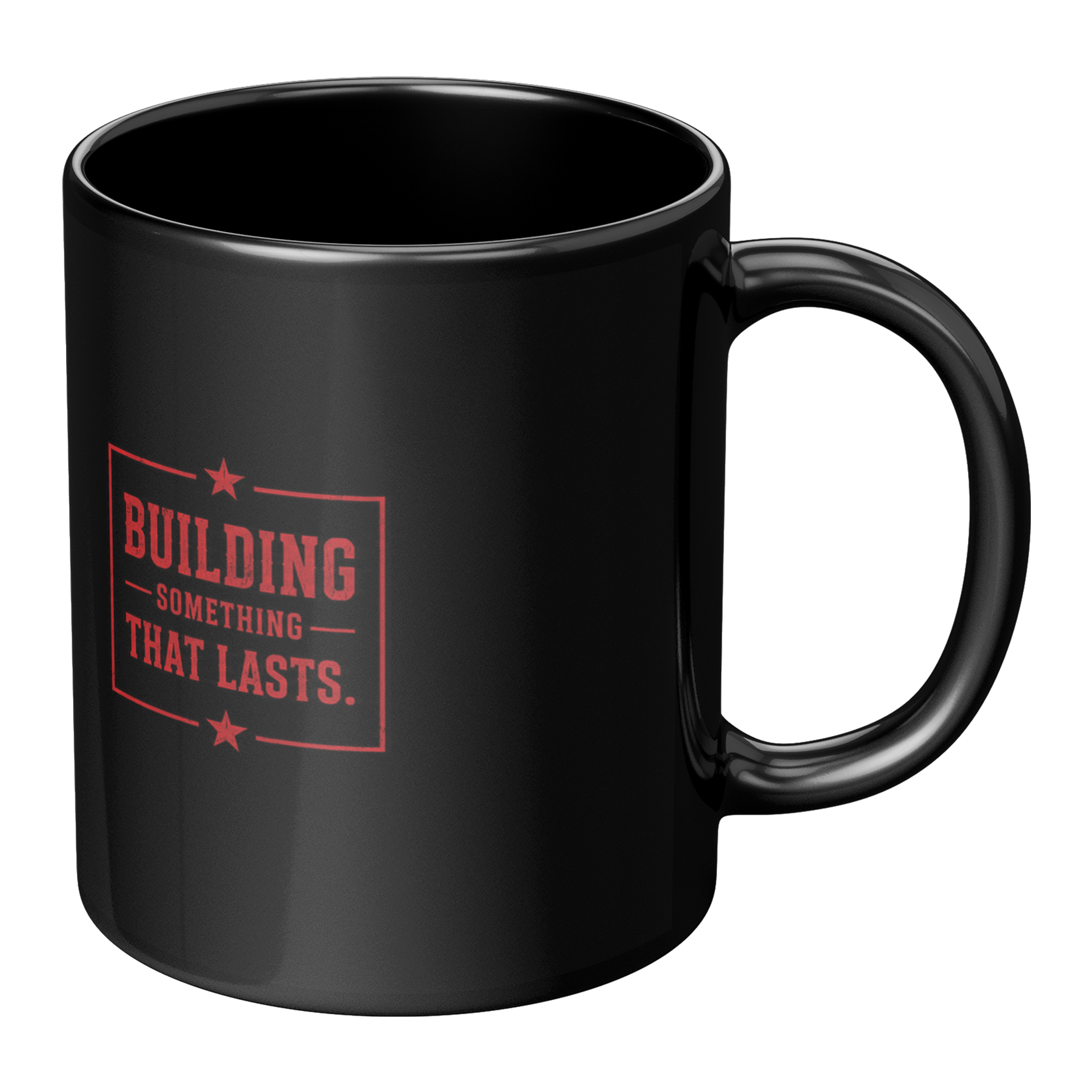 A glossy black ceramic mug with a red printed graphic on the front that reads 'BUILDING SOMETHING THAT LASTS.' with small star accents, shown on a plain white background.