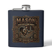 A matte navy blue flask with a silver screw cap and side spout, featuring a large vintage-style brown and gold graphic on the front that reads “MASON Bricklayer & Stone Worker” with an illustration of a mason working with bricks.