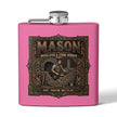 A pink square flask with a silver screw-top lid and side spout, featuring a large decorative front label that reads “MASON Bricklayer & Stone Worker” with an illustrated mason at a brick fireplace.