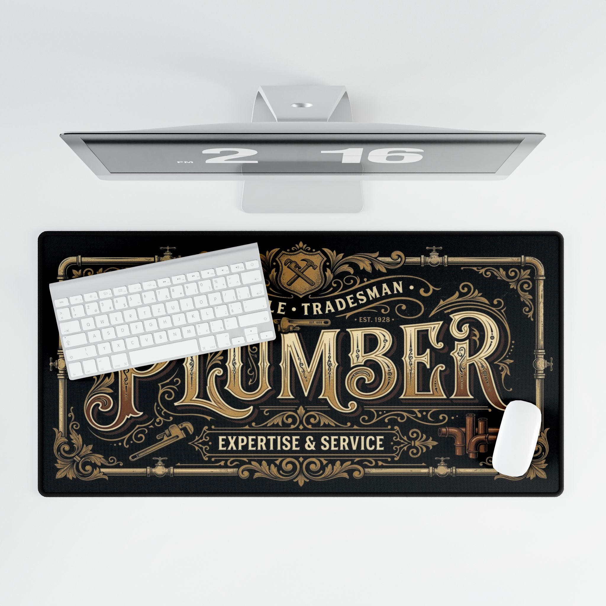 Decorative desk mat with 'Plumber' design on a desk setup.