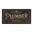 Decorative desk mat mouse pad with the word 'Plumber' in a decorative font on a black background