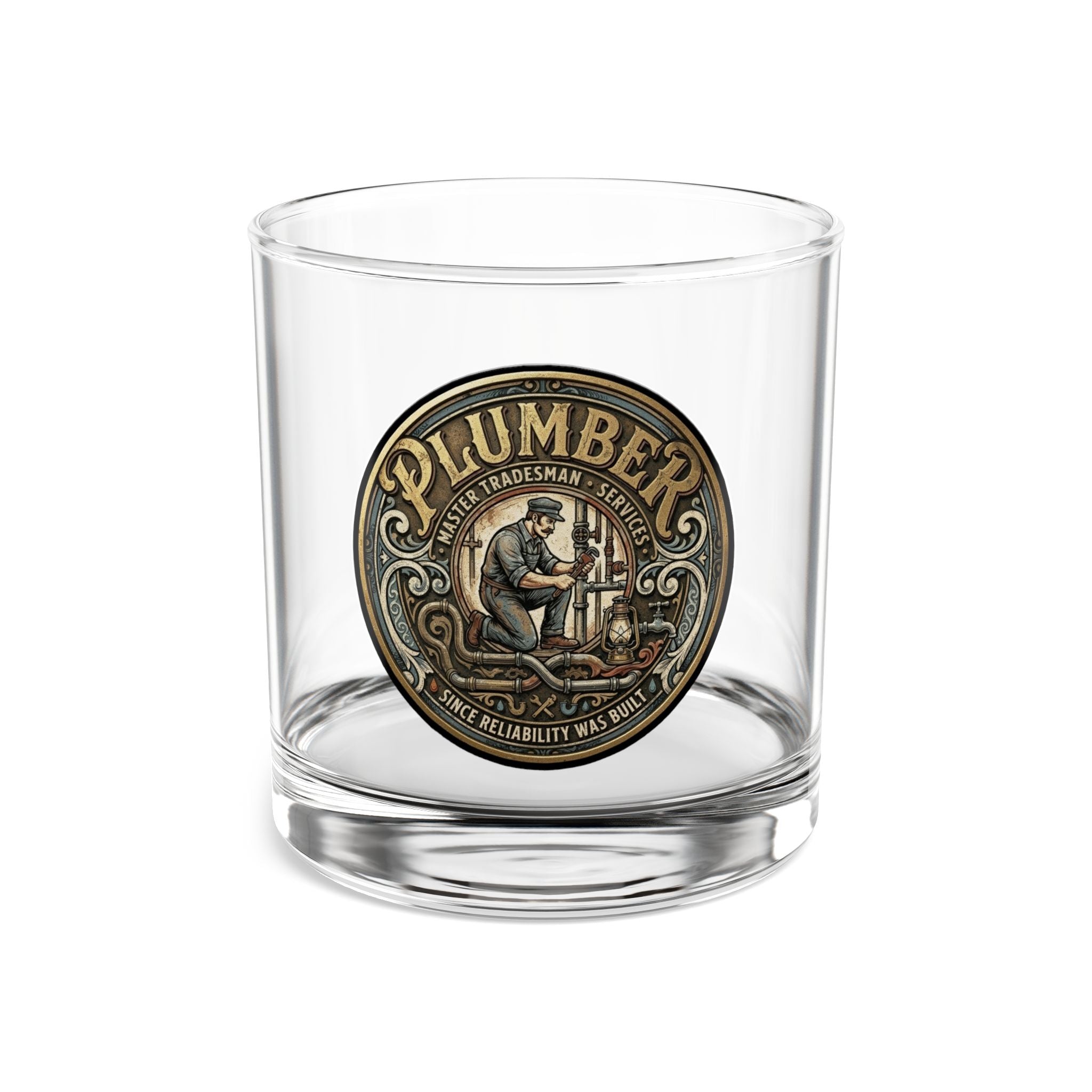 Clear glass tumbler with a 'Plumber' medallion on a white background