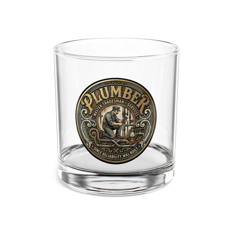 Clear glass tumbler with a 'Plumber' medallion on a white background