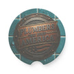 Round Soapstone Car Coaster with 'Plumbers That Build America' text on a blue tiled background