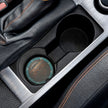 Car cup holder with a leather-textured car coaster inside
