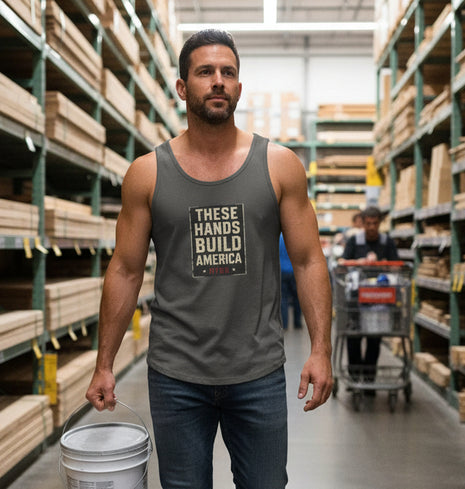 Pepper colored tank top with 'These Hands Build America' text against a hardware store background