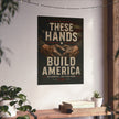 Poster with 'These Hands Build America' text on a wall above a wooden shelf with books and plants.